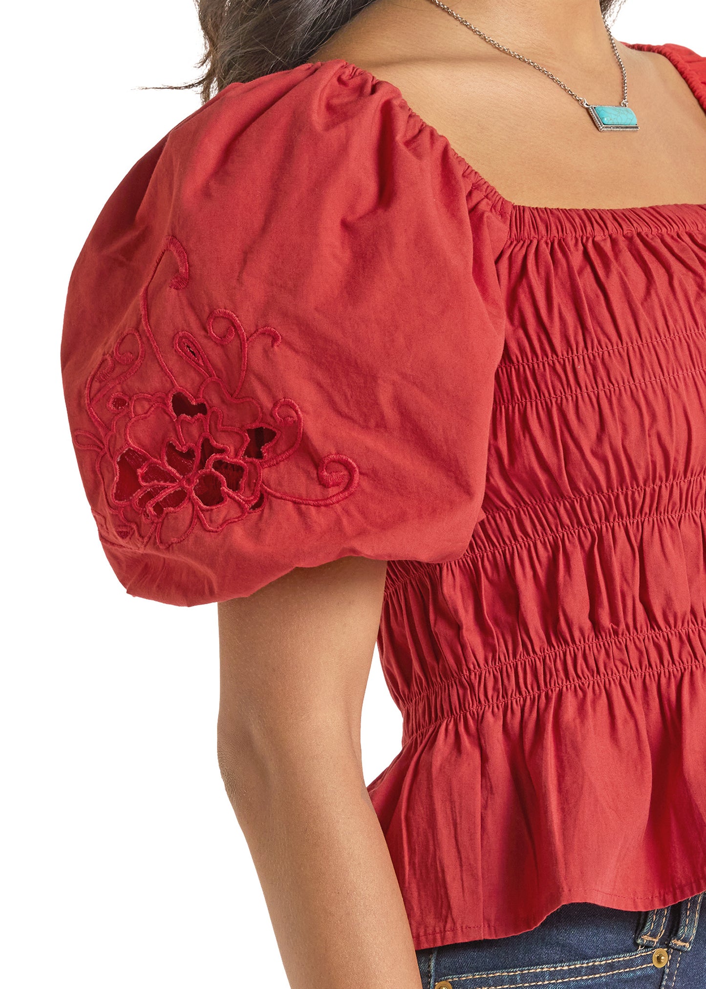 Red blouse with puff sleeves and floral embroidery on a white background