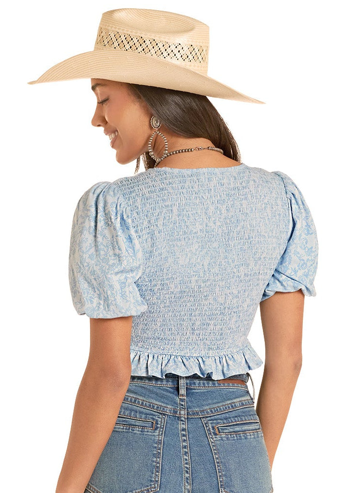 Woman wearing a blue denim outfit with a white background