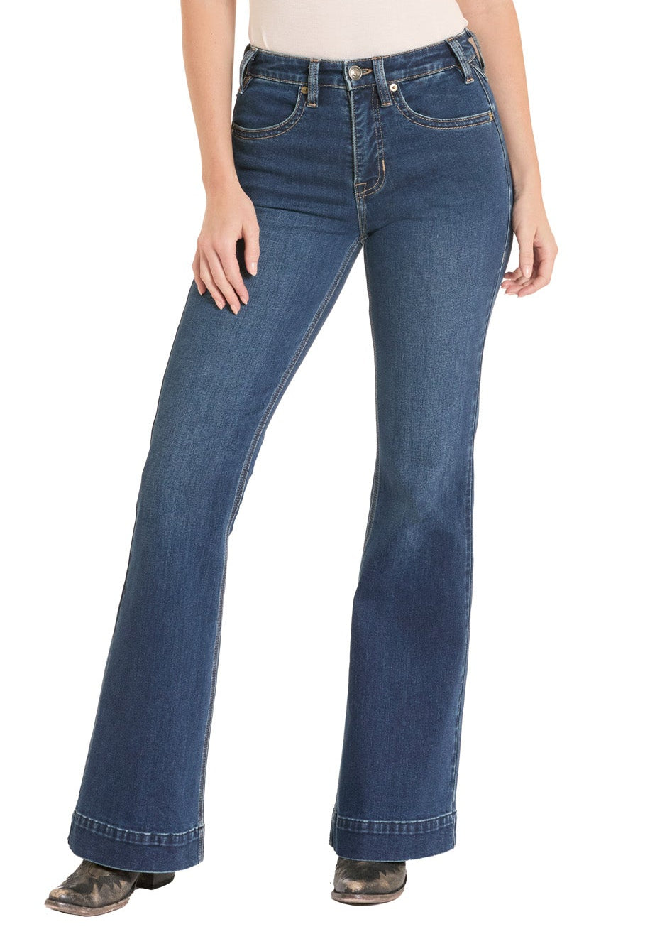 Woman wearing blue jeans and a beige shirt with a white background