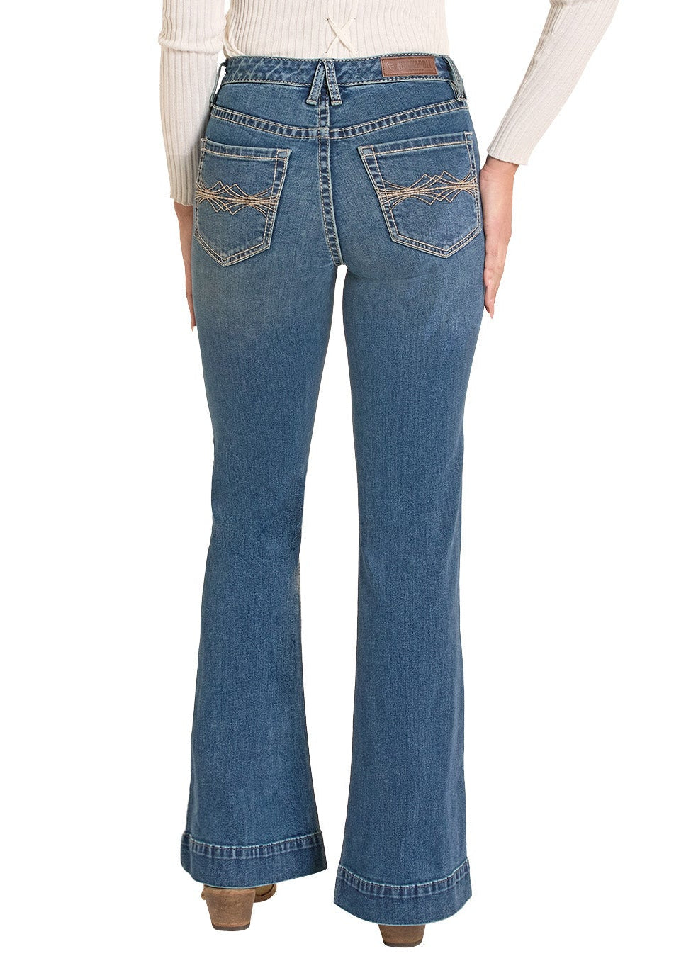 Woman wearing blue jeans and a beige hat on a white background