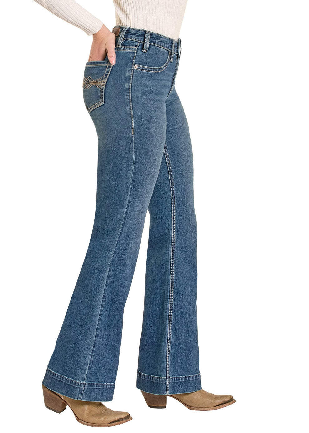 Woman wearing blue flared jeans and a beige cowboy hat on a white background