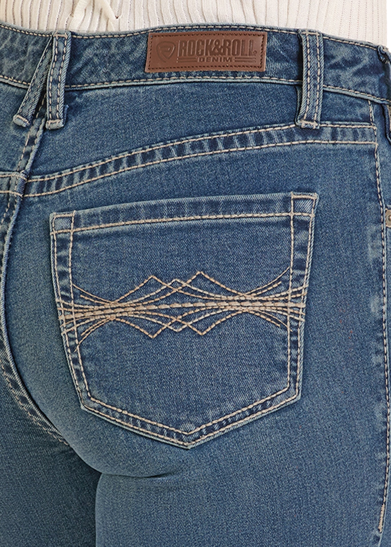 Close-up of blue jeans with a brand label on the back pocket.