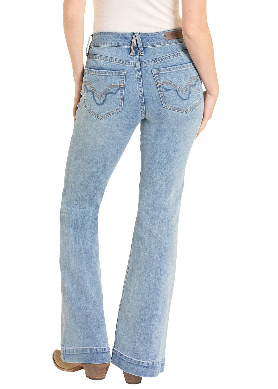 Woman wearing light blue jeans and a white t-shirt with a beige cowboy hat on a white background