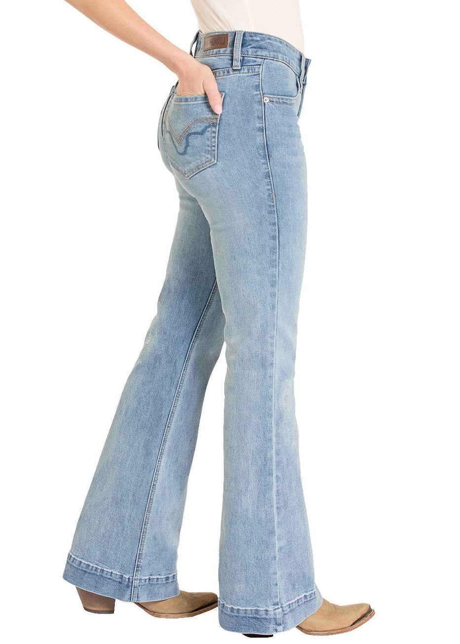 Woman wearing a cream shirt, light blue jeans, and a beige cowboy hat on a white background