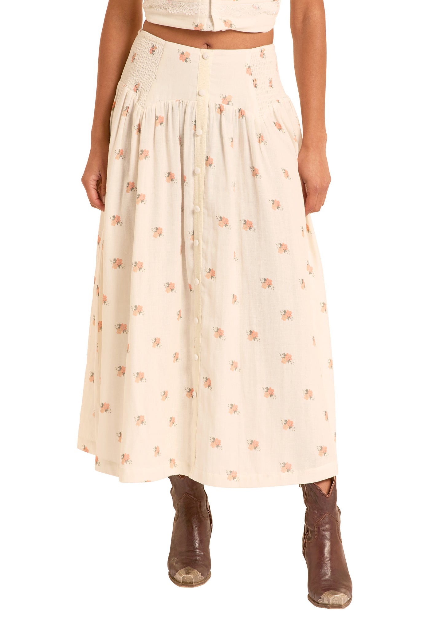 Woman wearing a cream-colored skirt with a subtle pattern on a white background