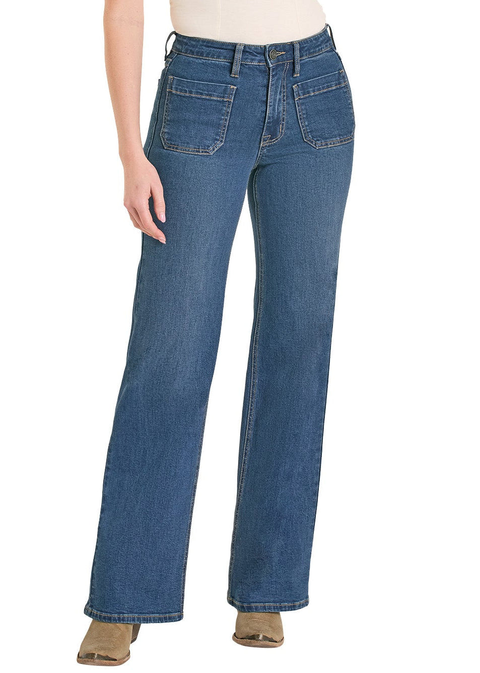 Woman wearing blue jeans and a beige top with a white background