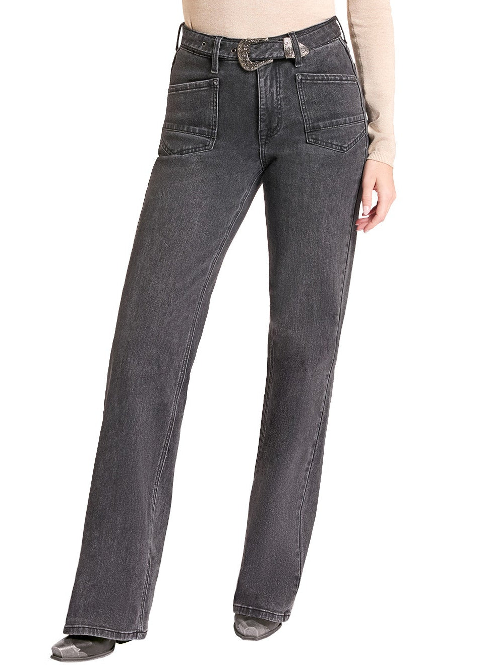 A woman modeling a pair of dark gray wide-leg jeans with a beige long-sleeve top and a black cowboy hat, standing against a solid white background.