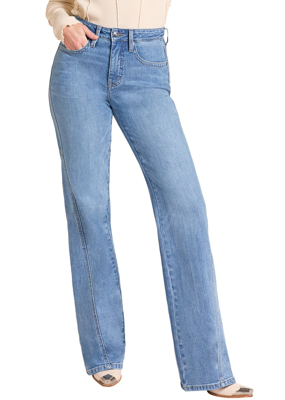 A woman modeling a pair of light-wash blue flare jeans with a beige long-sleeve top and a tan cowboy hat, standing against a plain white background.