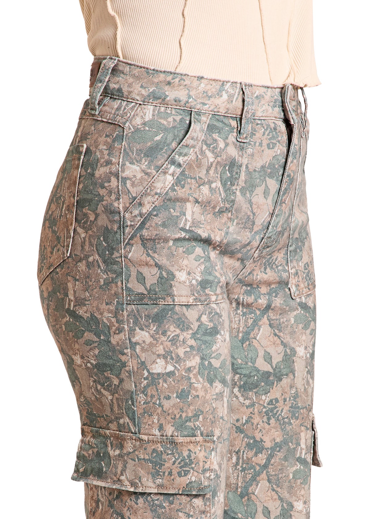 Side view of a person wearing cargo shorts with a green and brown camouflage pattern, paired with a light beige ribbed top, against a plain white background.