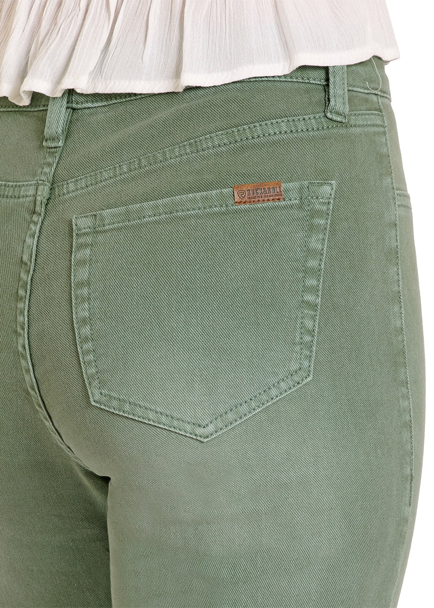 Green pants with a brand label on the back pocket against a white background