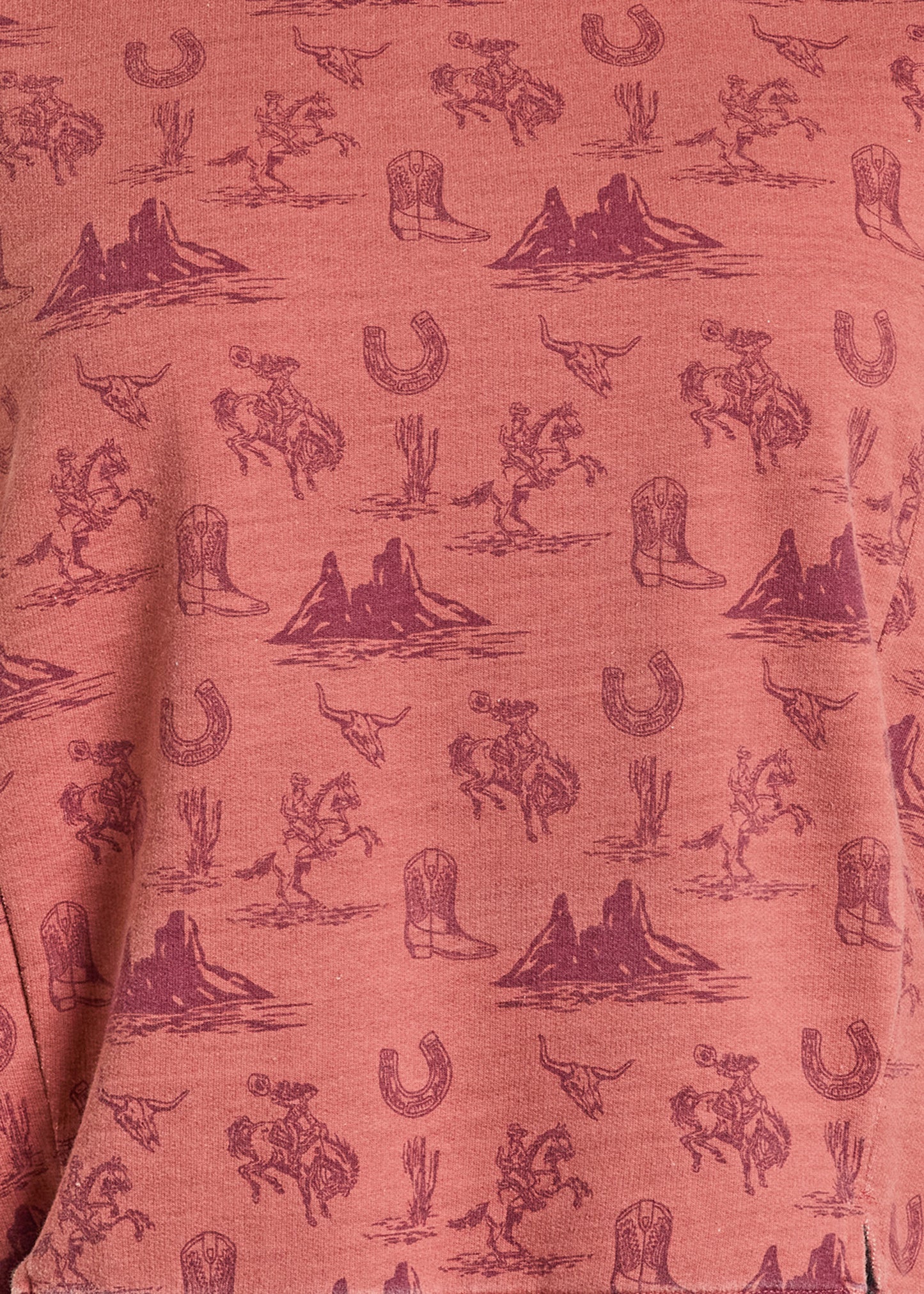 Red fabric with cowboy-themed pattern featuring horses, boots, and mountains.