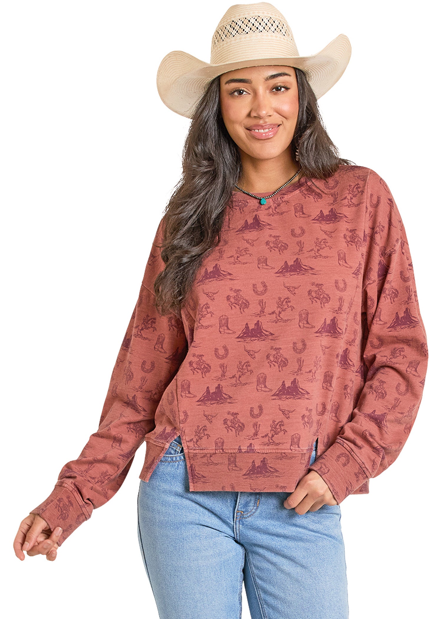 Woman wearing a patterned long-sleeve shirt and cowboy hat on a white background