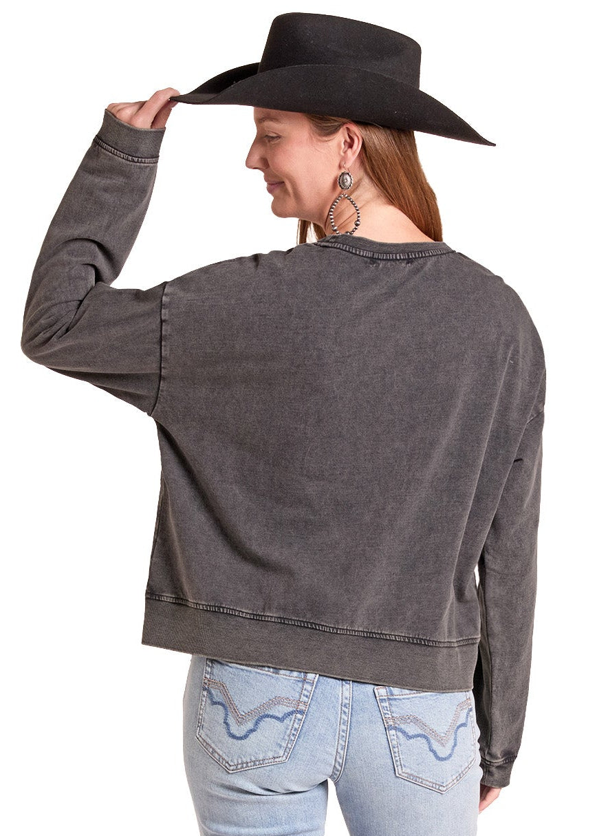 A woman shown from the back wearing a dark gray washed long-sleeve cropped sweatshirt, light blue jeans, and a black cowboy hat, set against a plain white background.