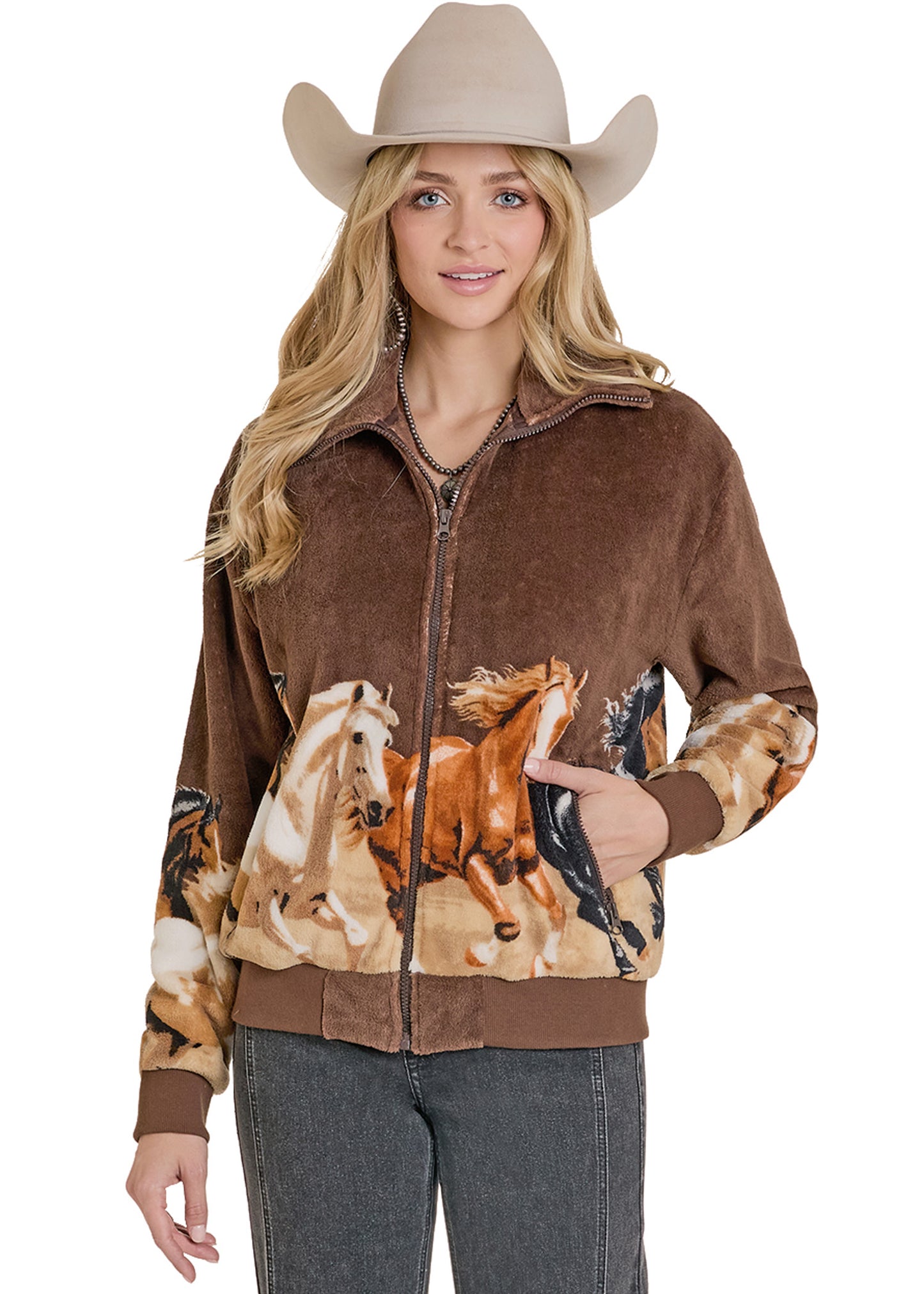 Woman wearing a brown jacket with horse design and a cowboy hat on a white background