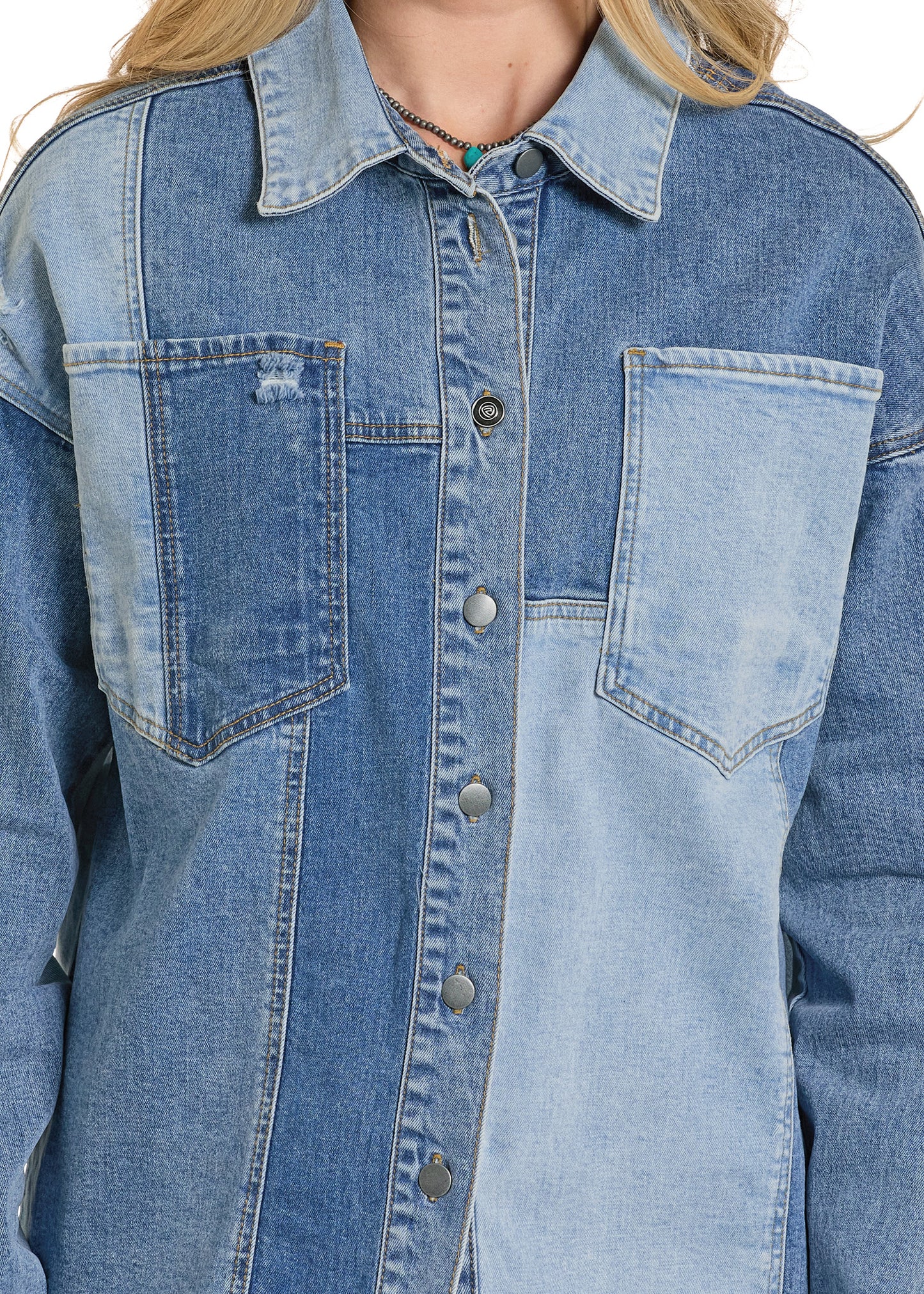 Close-up of a blue denim jacket with button details