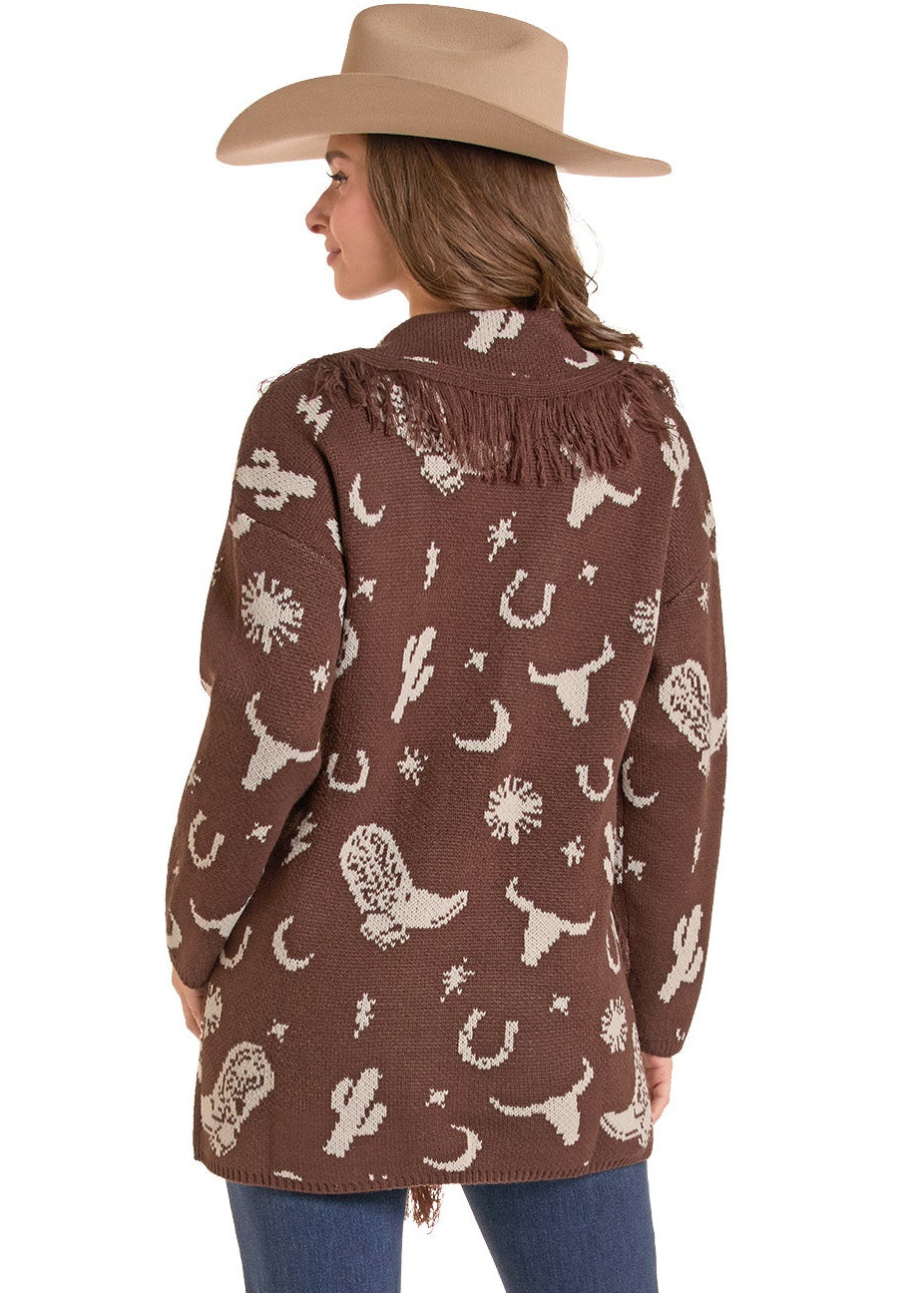 A woman shown from the back wearing a brown long-sleeve fringed shirt jacket with a white western-themed print.