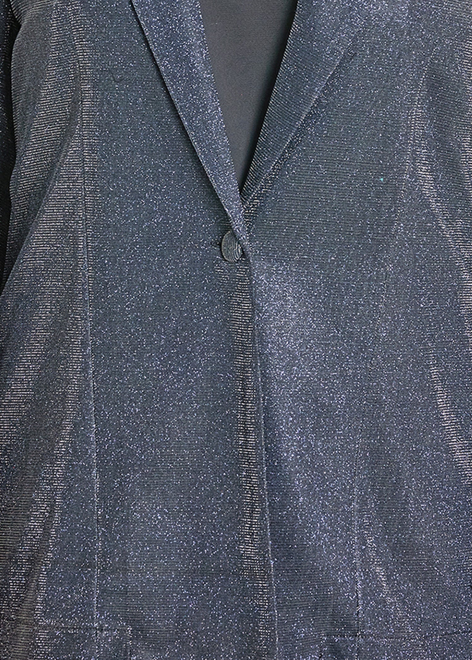 Close-up of a textured gray fabric with a button detail