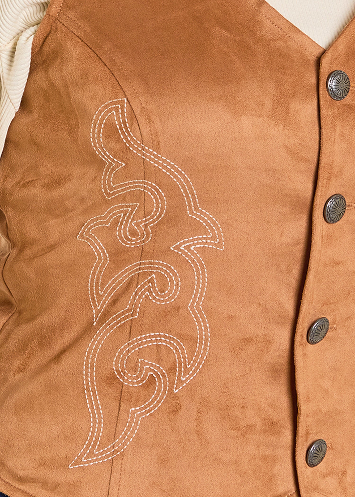 Close-up of a brown leather vest with decorative stitching and buttons.