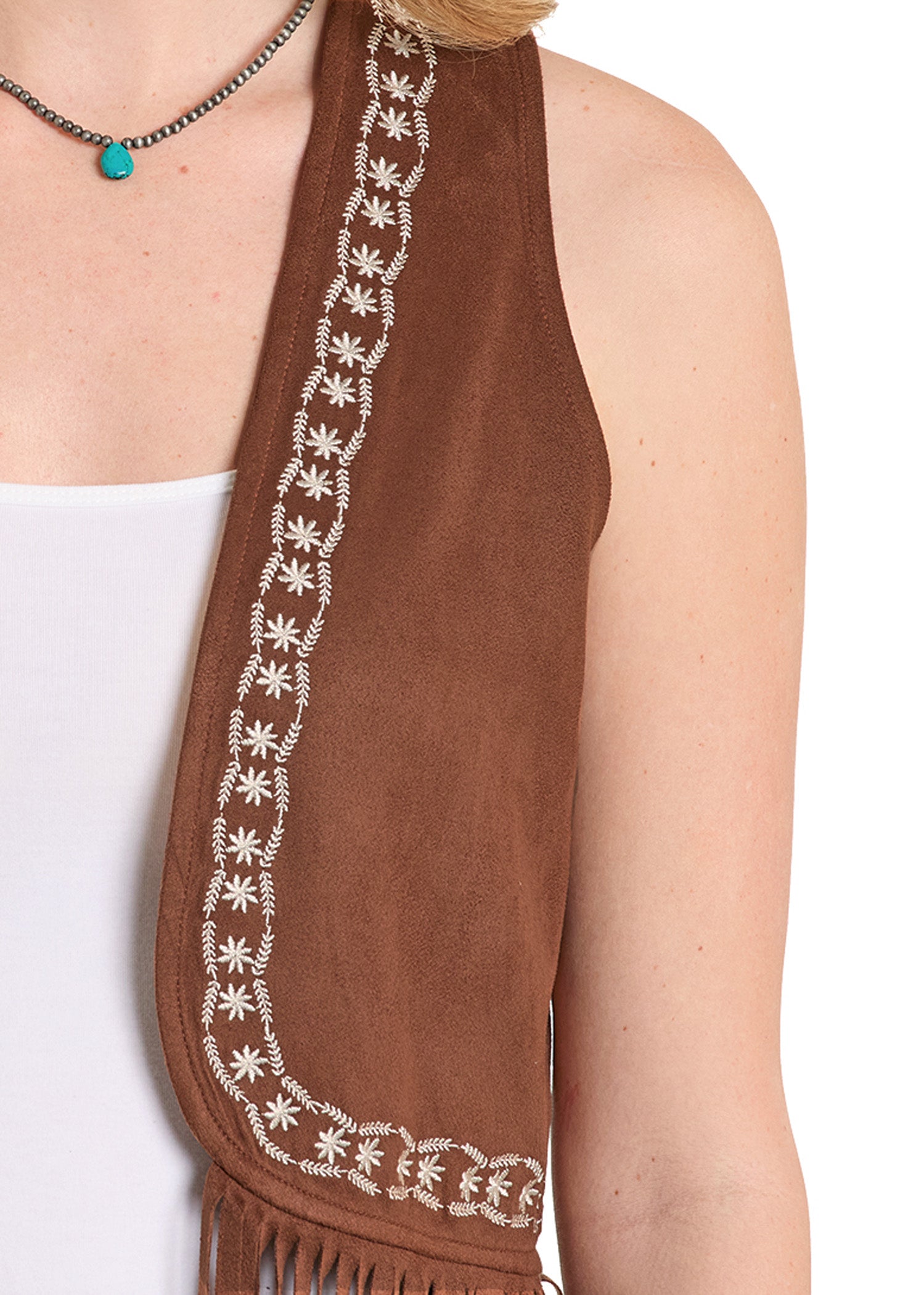 Brown scarf with white patterns and fringe, worn by a person on a white background