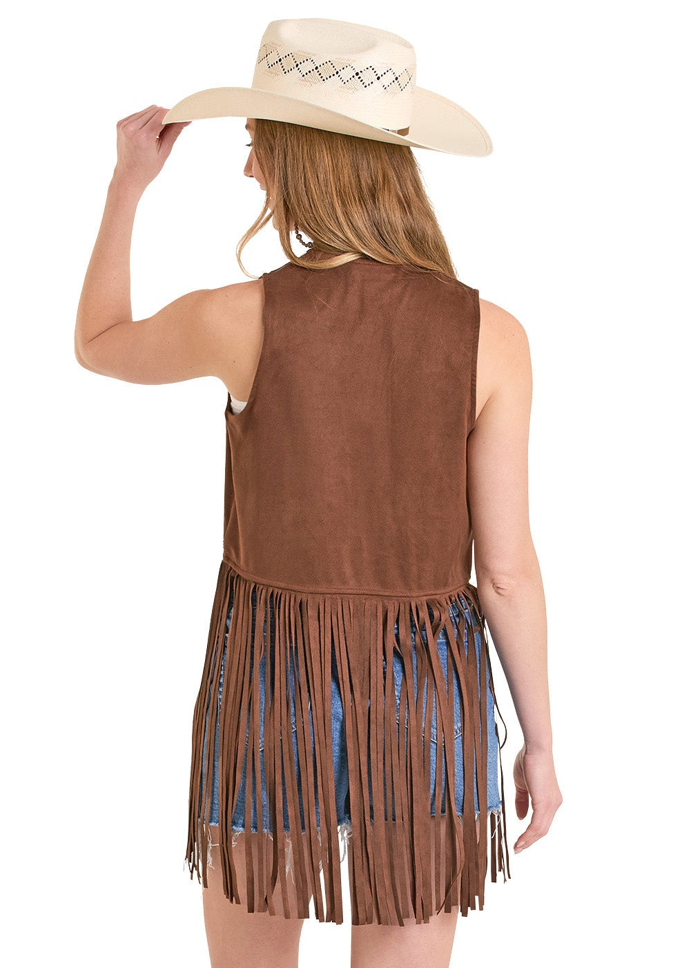 Woman wearing a brown fringe dress with a cowboy hat and white boots on a white background