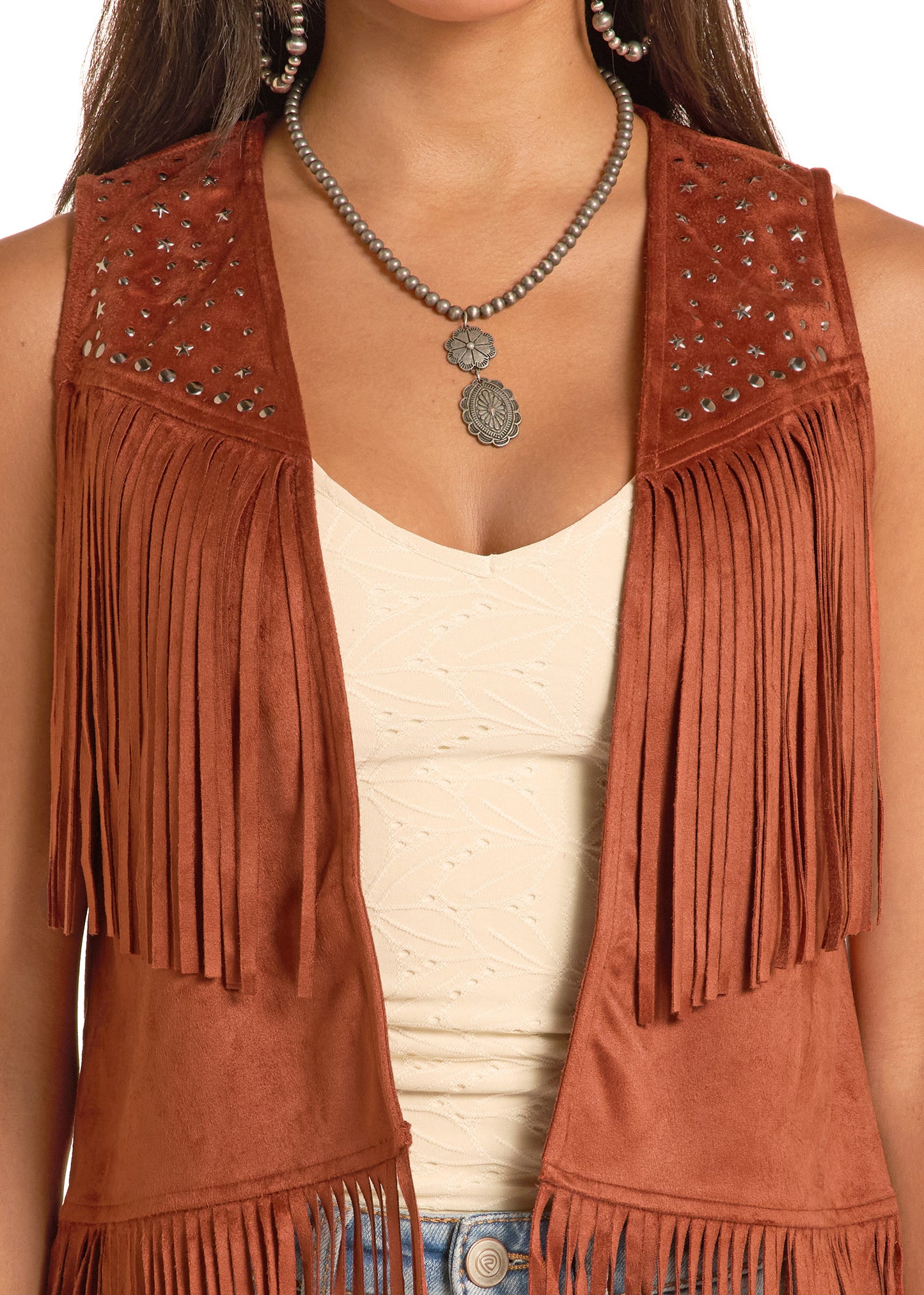 Brown suede fringe vest worn by a person, with a focus on the vest's details.