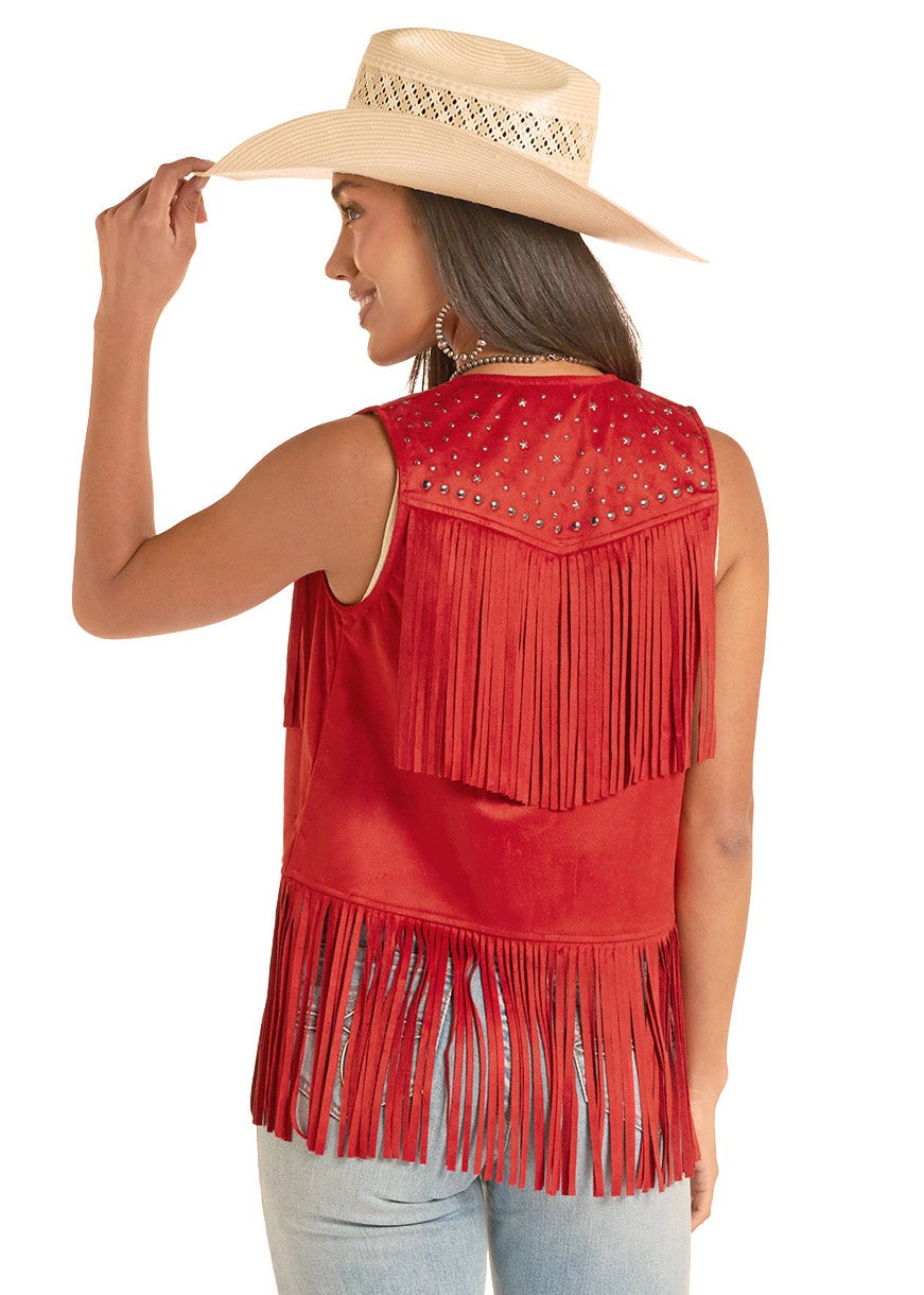 Woman wearing a red fringe top and light blue jeans on a white background