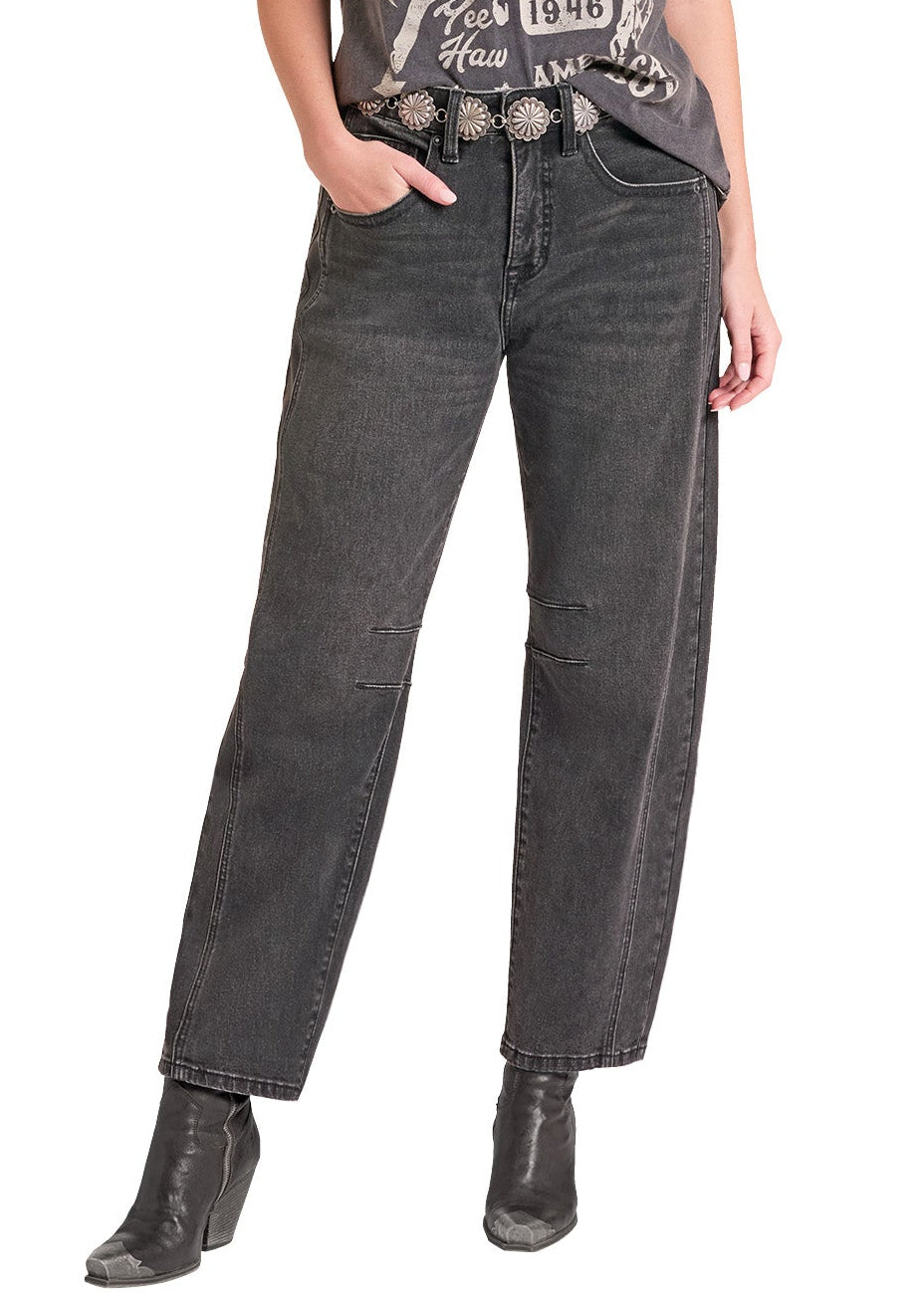 A woman modeling a dark gray graphic t-shirt with a western design, paired with dark gray jeans, a black cowboy hat, and black boots against a plain white background.