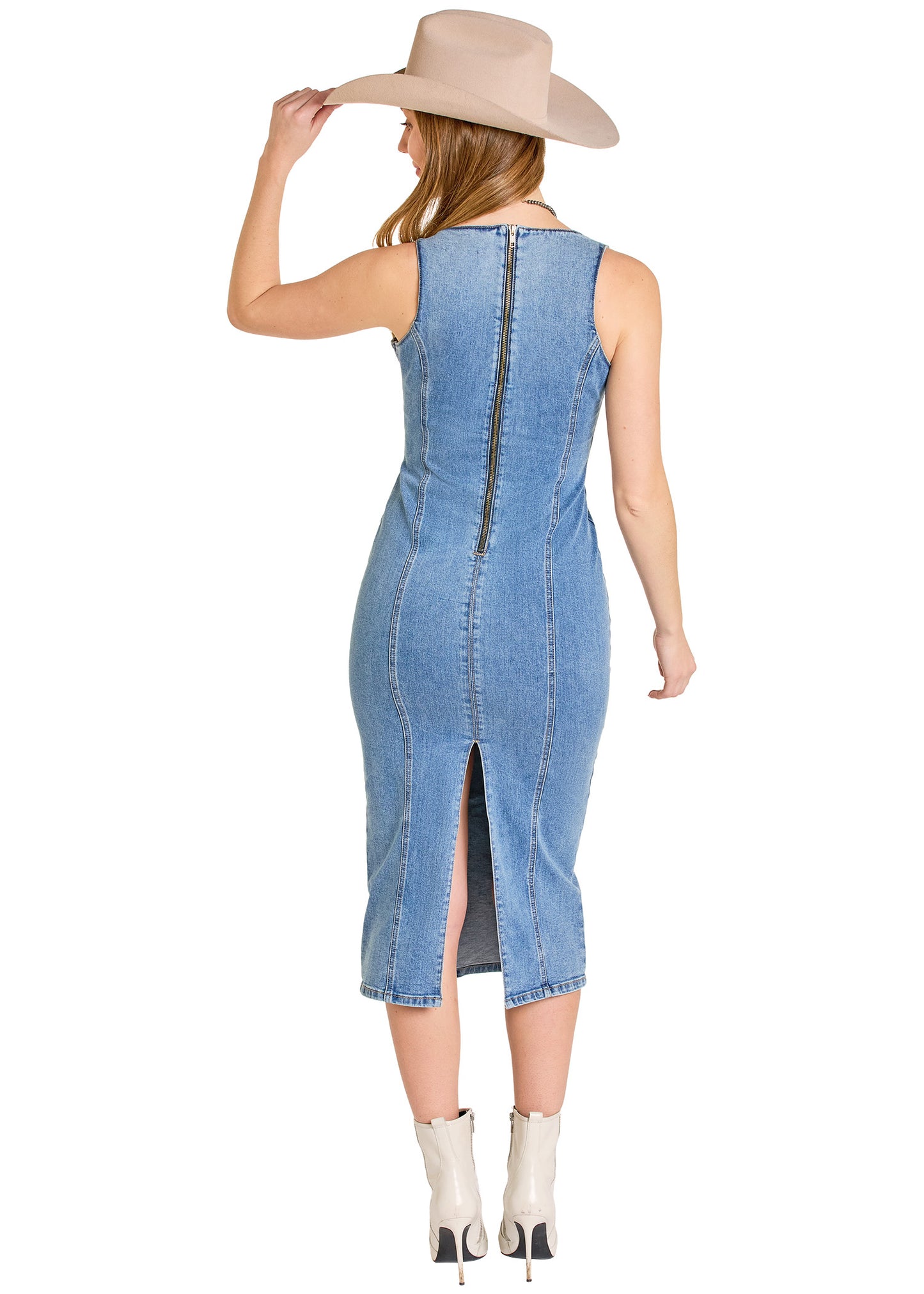 Woman wearing a denim dress with a back zipper and side slit, standing against a white background.