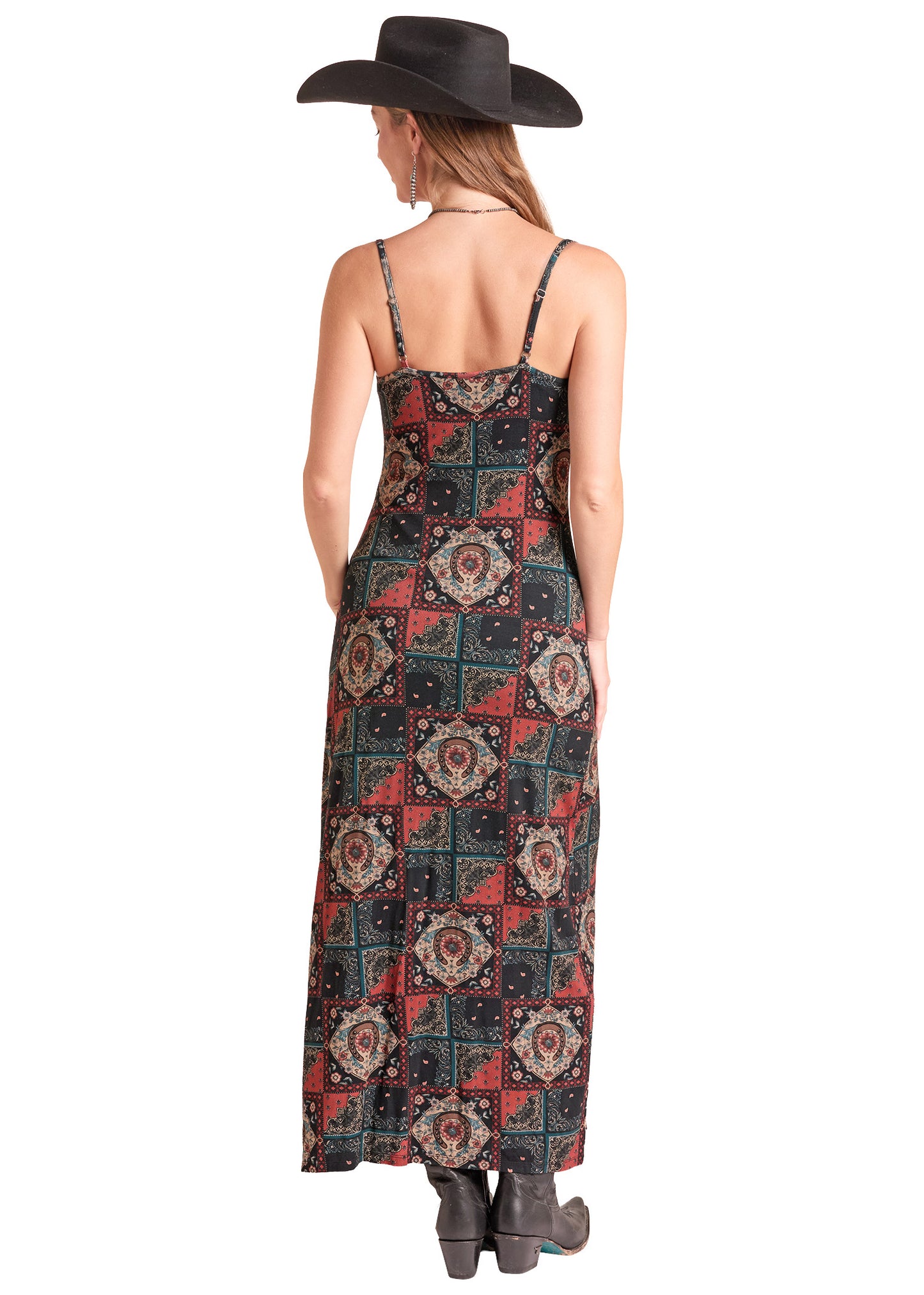 A woman shown from the back wearing a long spaghetti-strap maxi dress with a red, black, and beige geometric patchwork pattern.