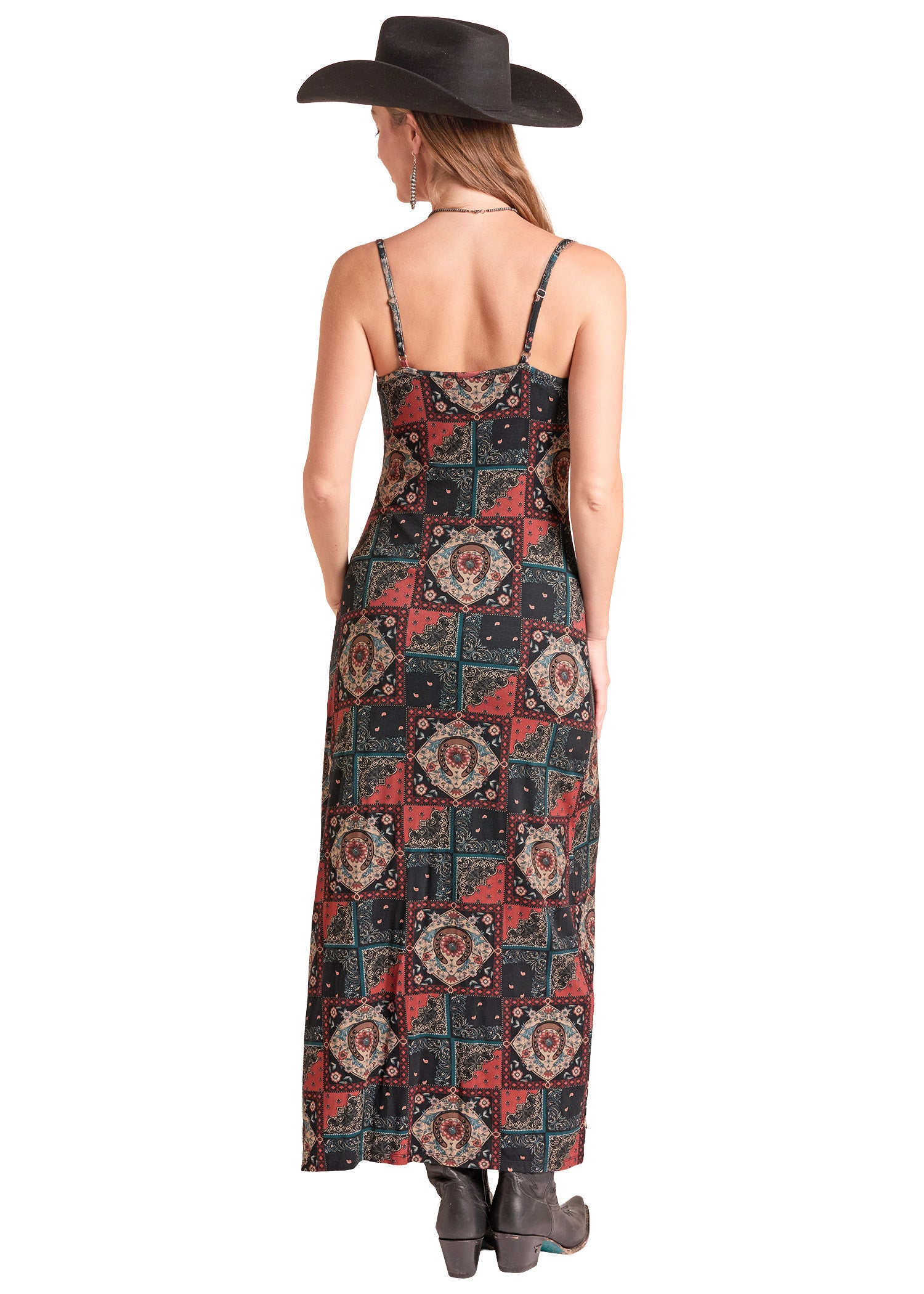 A woman shown from the back wearing a long spaghetti-strap maxi dress with a red, black, and beige geometric patchwork pattern.