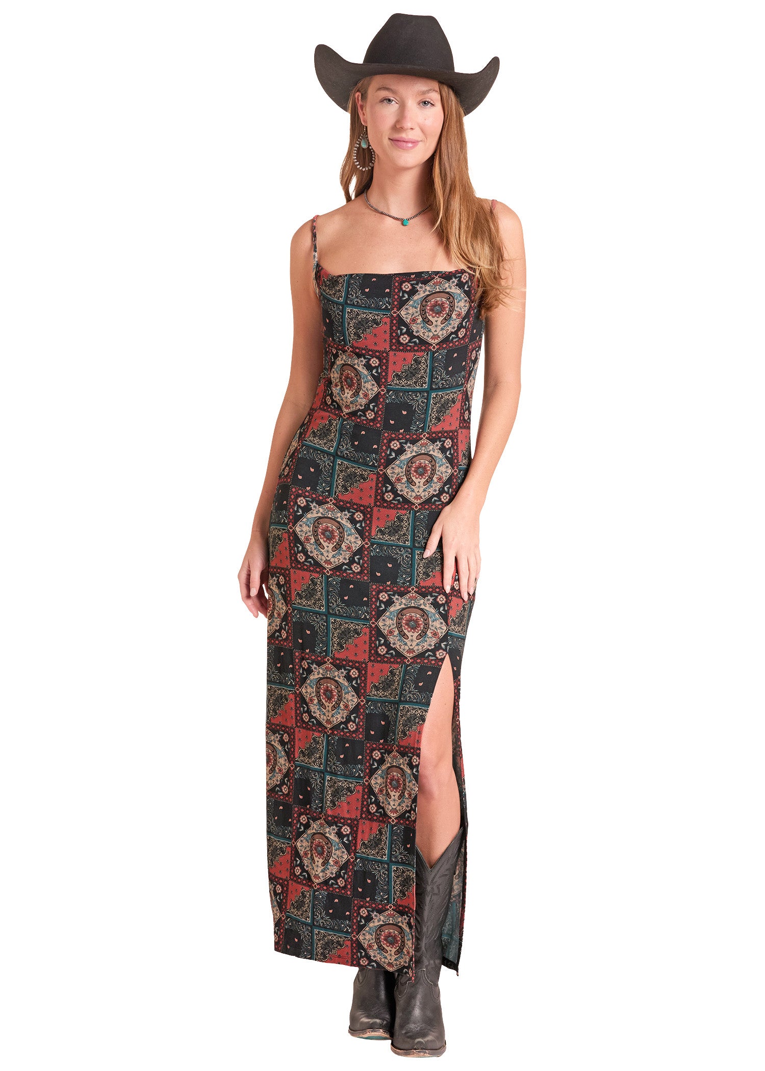 A woman modeling a sleeveless maxi dress with a red, black, and teal patchwork paisley pattern.