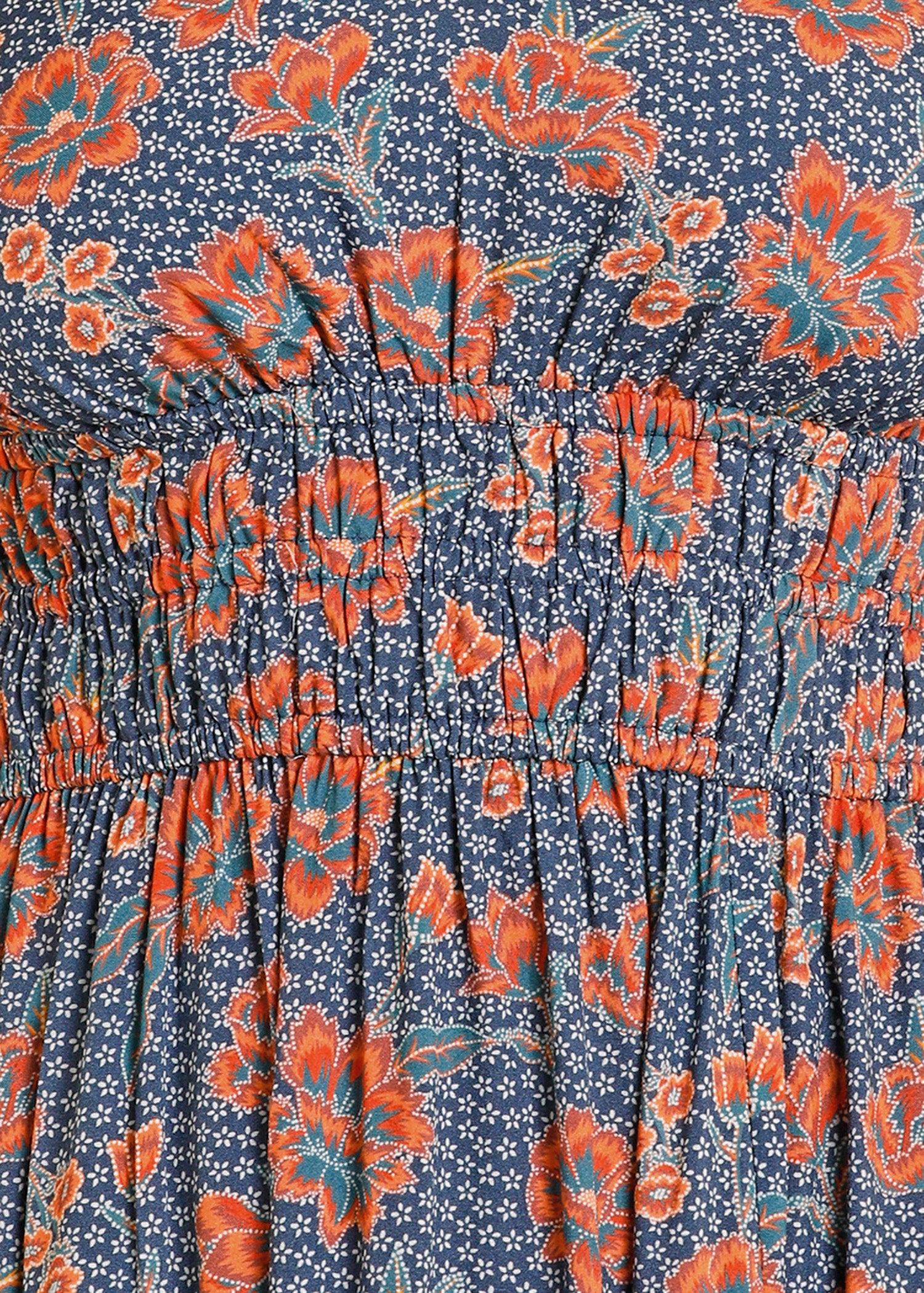 Floral patterned fabric with orange flowers on a blue background