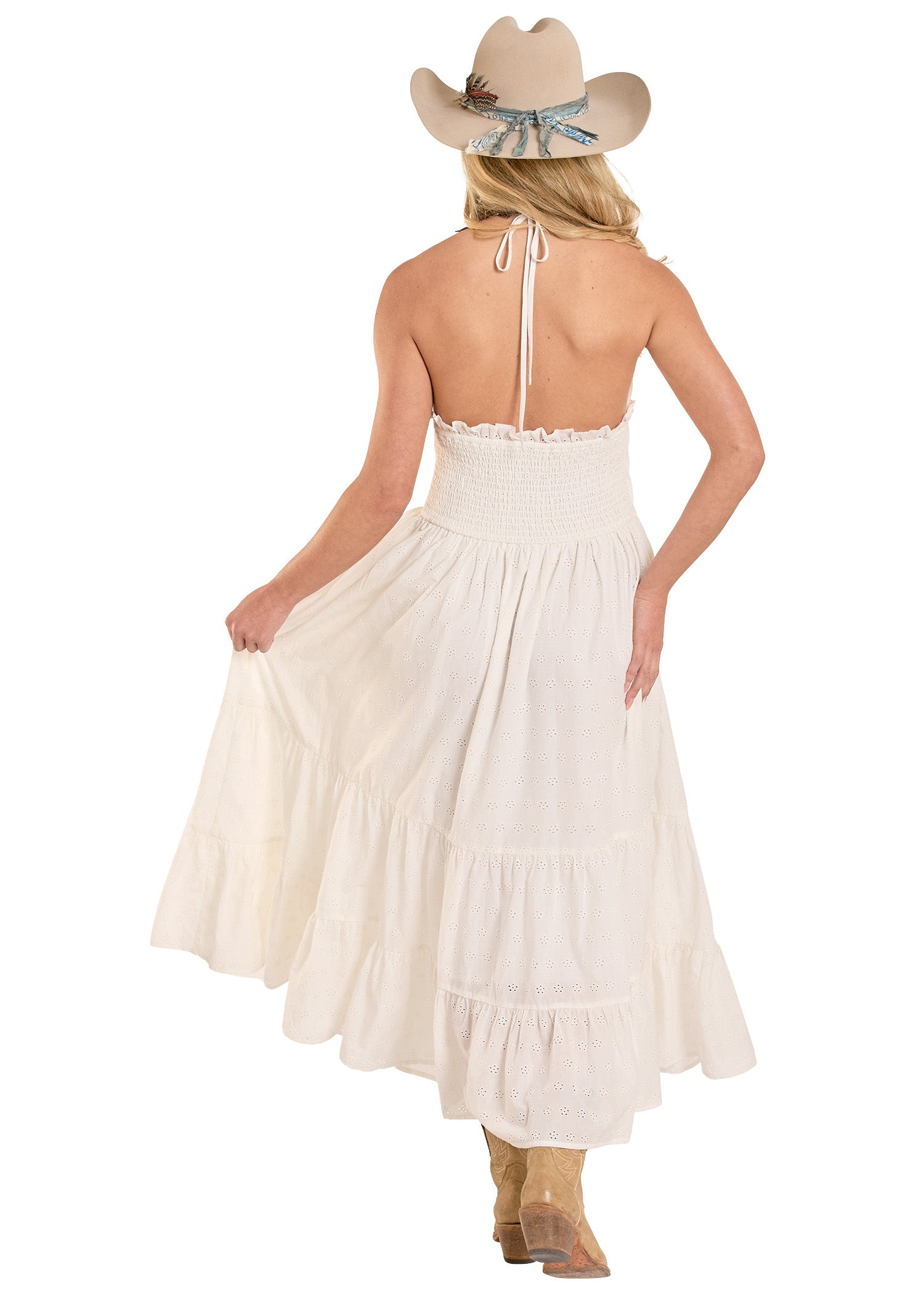 Woman wearing a white dress and cowboy hat on a white background