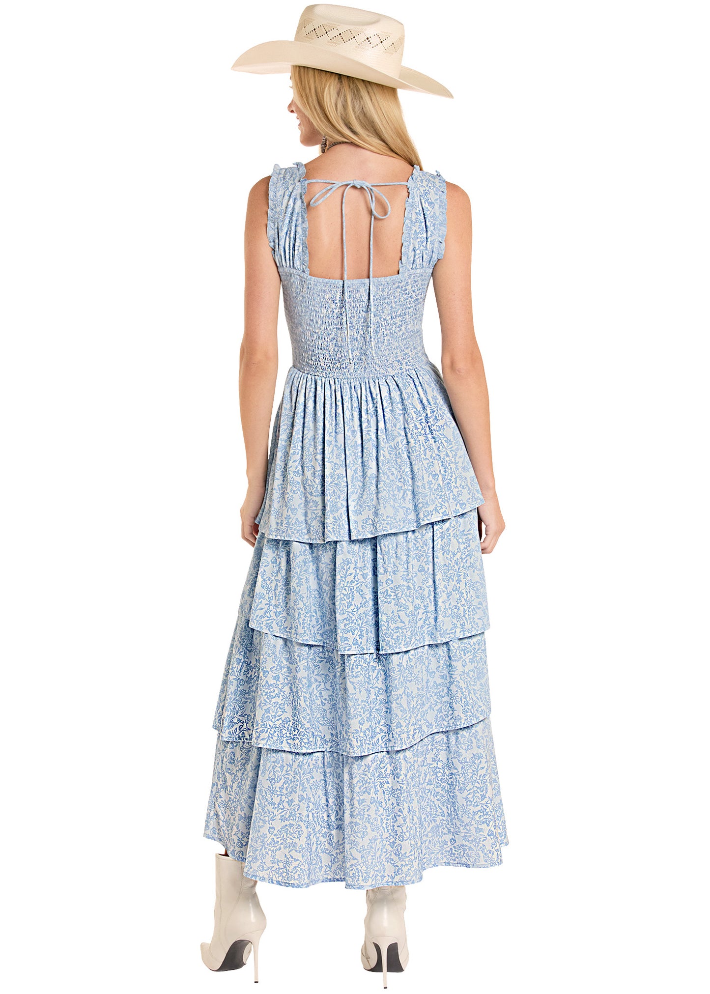 Woman wearing a blue tiered dress with a white background