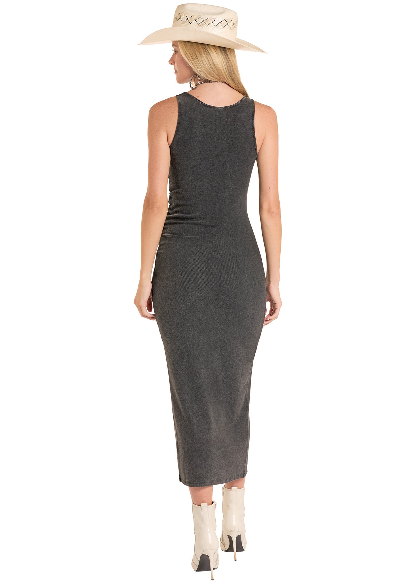 Woman wearing a black sleeveless dress and beige hat on a white background