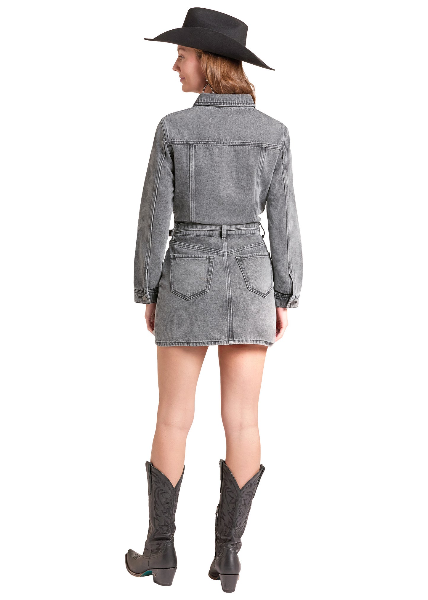 A woman shown from the back wearing a gray denim long-sleeve shirt dress with a matching belt, a black wide-brim hat, and dark gray cowboy boots, against a plain white background.