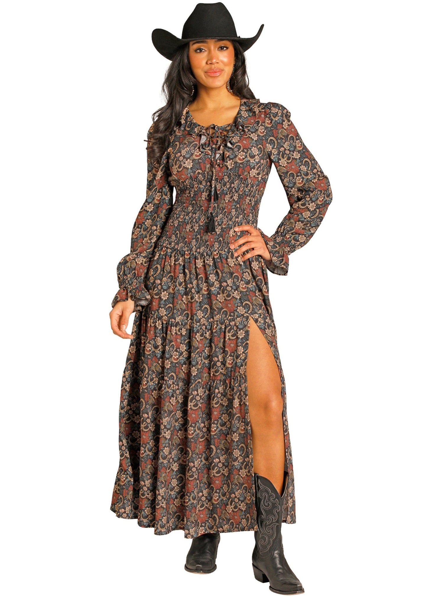 Woman wearing a long floral dress with a slit and cowboy hat on a white background