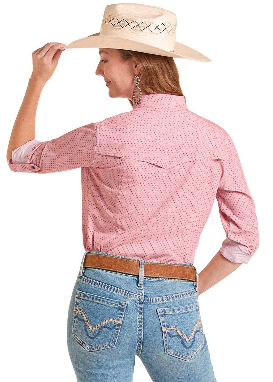 Woman wearing a pink shirt and blue jeans with a cowboy hat on a white background