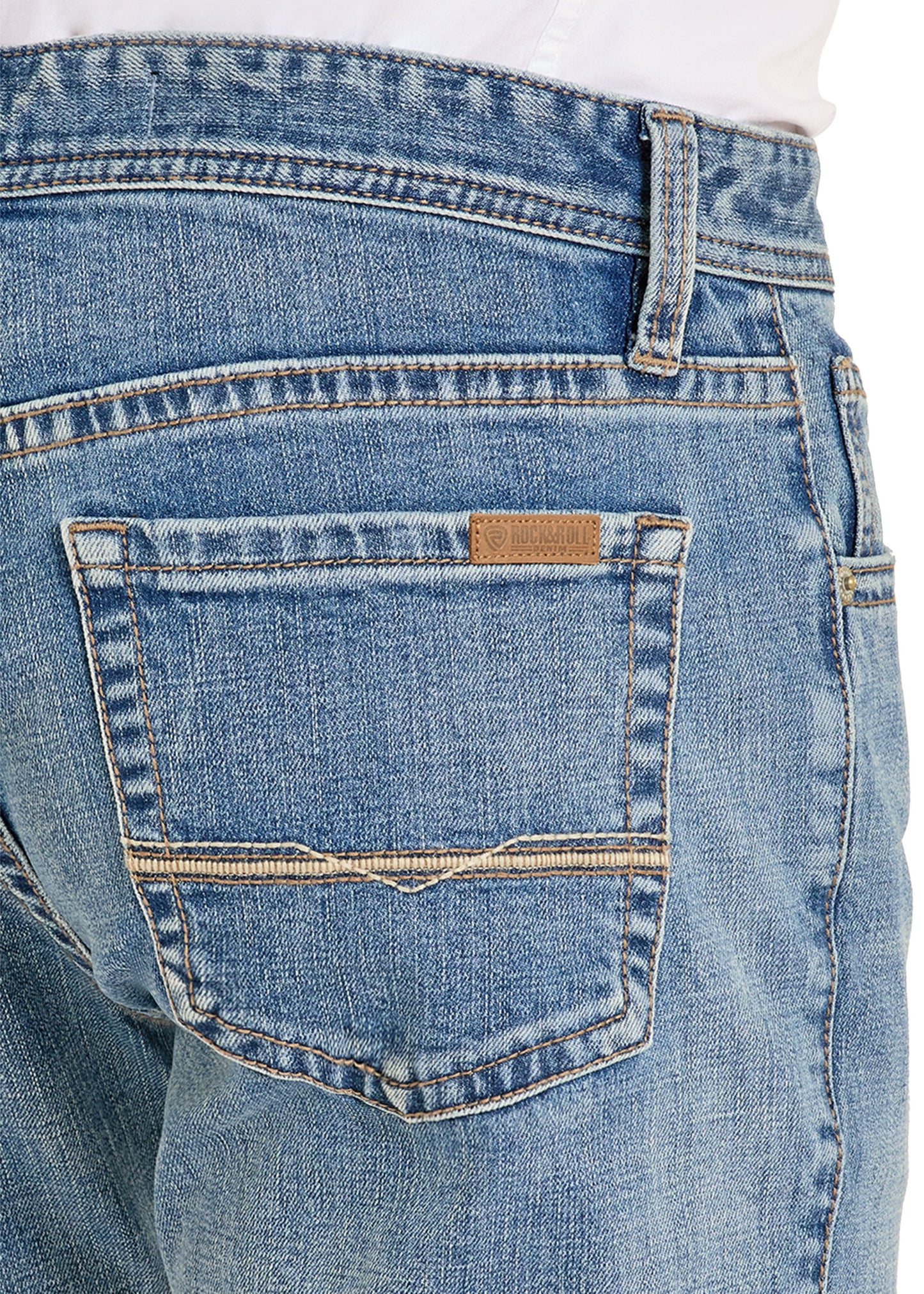 Close-up of blue jeans with a brand label on the back pocket.