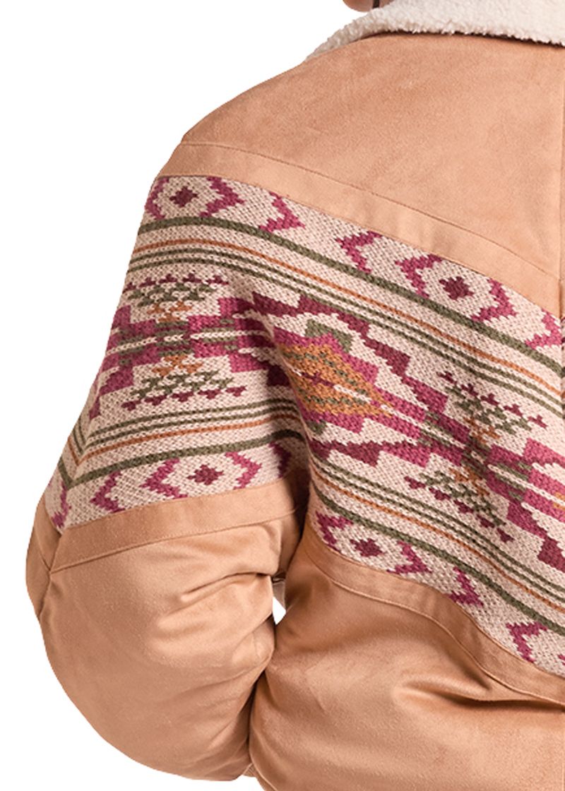 Close-up of the back of a tan suede jacket with a wide, colorful geometric patterned woven panel across the upper back and shoulders.