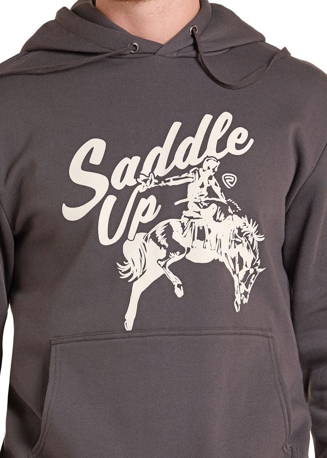 A close-up of a dark gray hoodie featuring a white graphic print of a cowboy riding a bucking horse with the text 'Saddle Up' across the chest.
