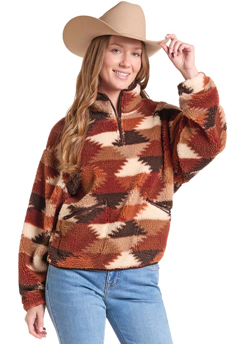A woman wearing a brown, rust, and beige southwestern patterned sherpa fleece quarter-zip pullover sweater, styled with a tan cowboy hat and blue jeans, against a solid white background.