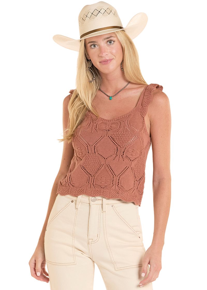 Woman wearing a brown sleeveless top and beige cowboy hat on a white background