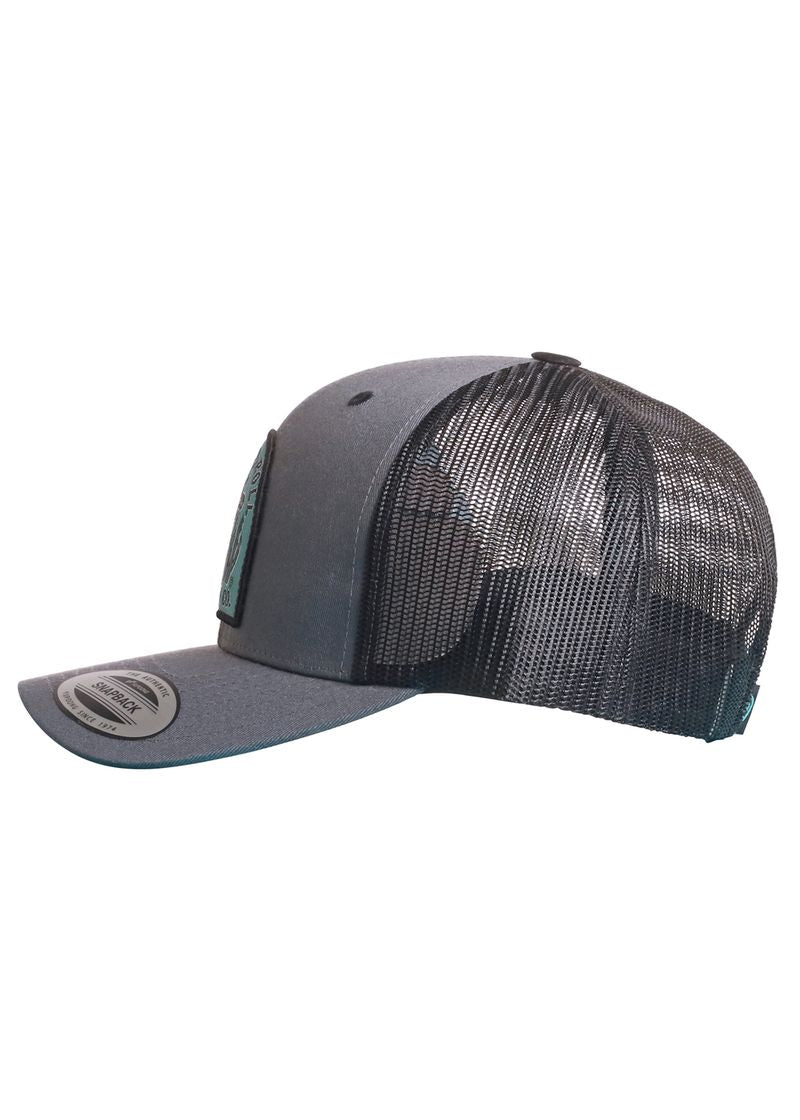 The Rock & Roll Denim Rock & Roll Cactus Skull Cap is a gray and black trucker hat with a flat brim, mesh back, front patch, and adjustable snapback closure, shown from the side.
