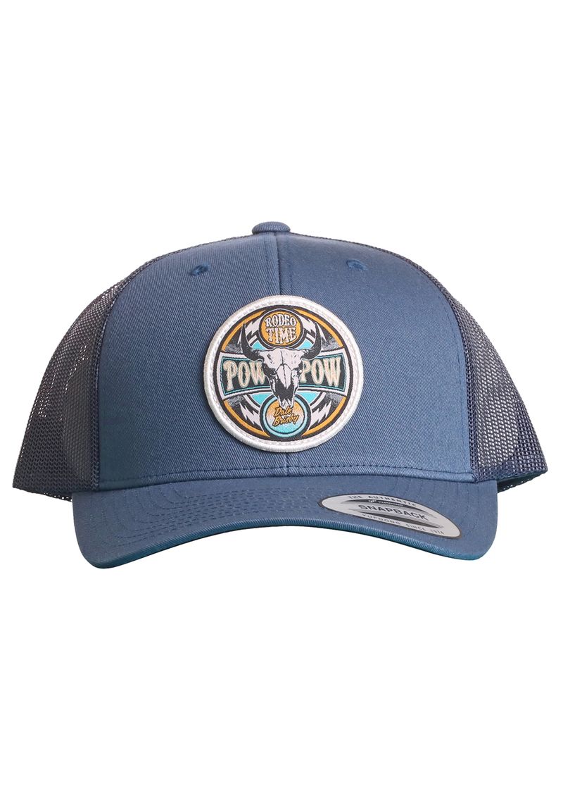 The Dale Brisby Pow Pow Cap by Rock & Roll Denim is a blue mesh trucker hat with a circular steer skull patch and "Rodeo Time POW! POW!" text, featuring a curved brim, sticker on the bill, and snapback closure.