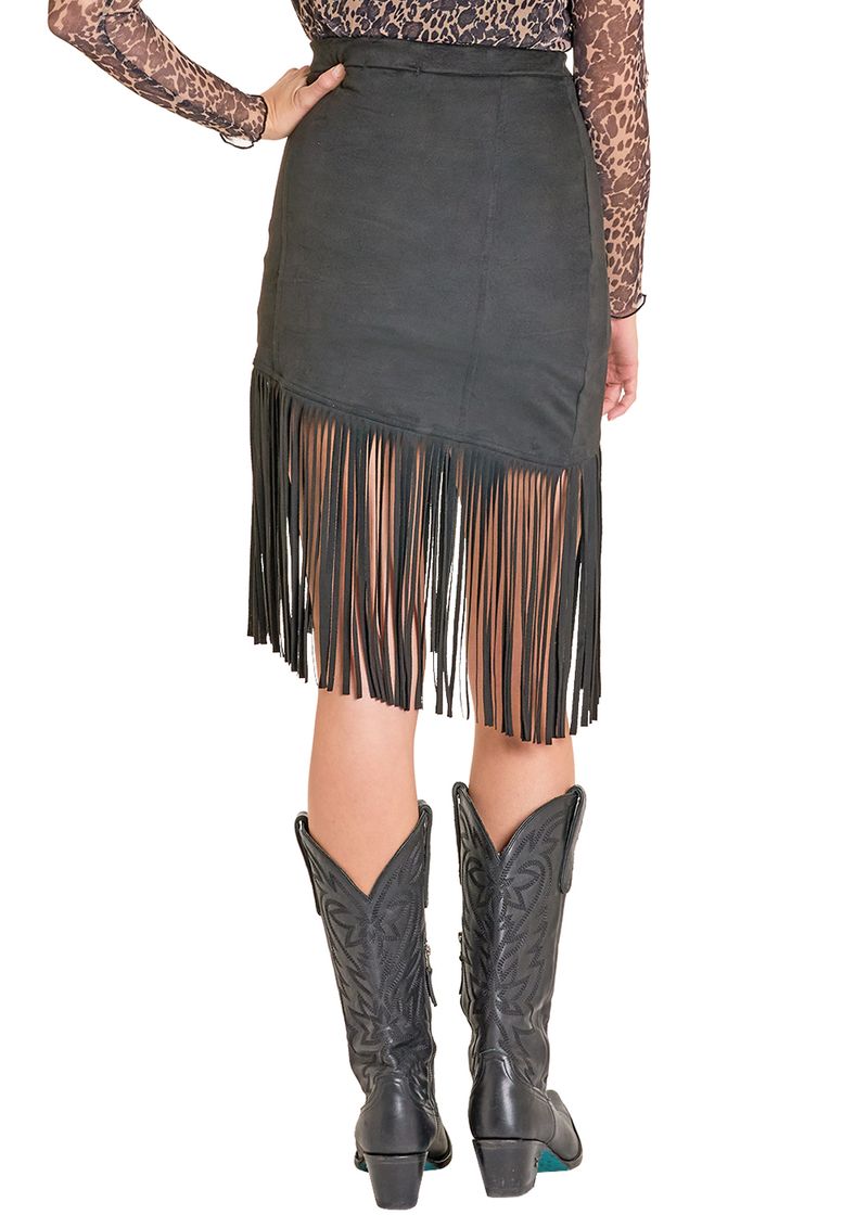 A person is seen from the back wearing black cowboy boots, a sheer animal-print long-sleeve top, and the Rock & Roll Denim Asymmetrical Microsuede Fringe Skirt with a long, dramatic hemline.
